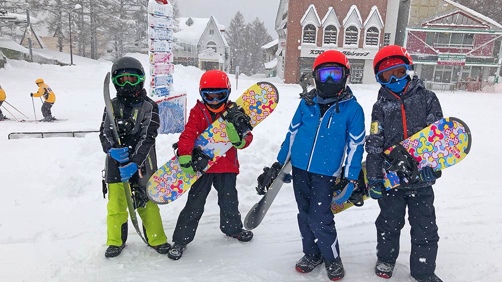 kids enjoy the snow at family skiing destination in japan ski resort madarao